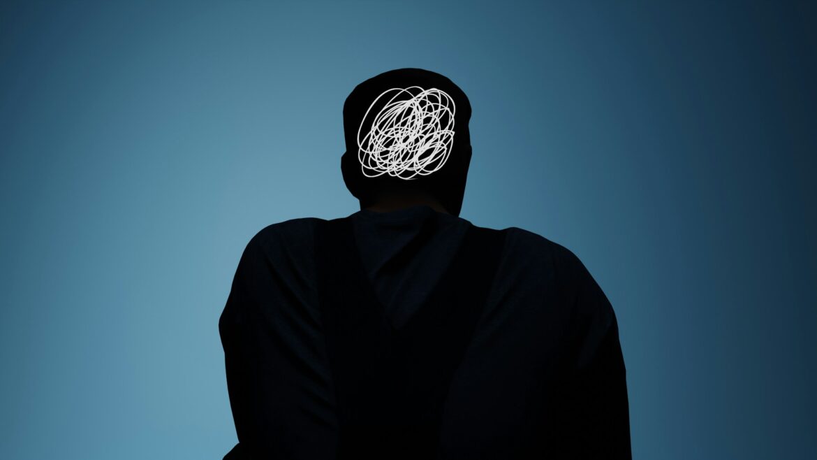 Person shown from behind wearing dark clothing; head covered with a white scribble, against a blue gradient background, suggesting confusion or tangled thoughts