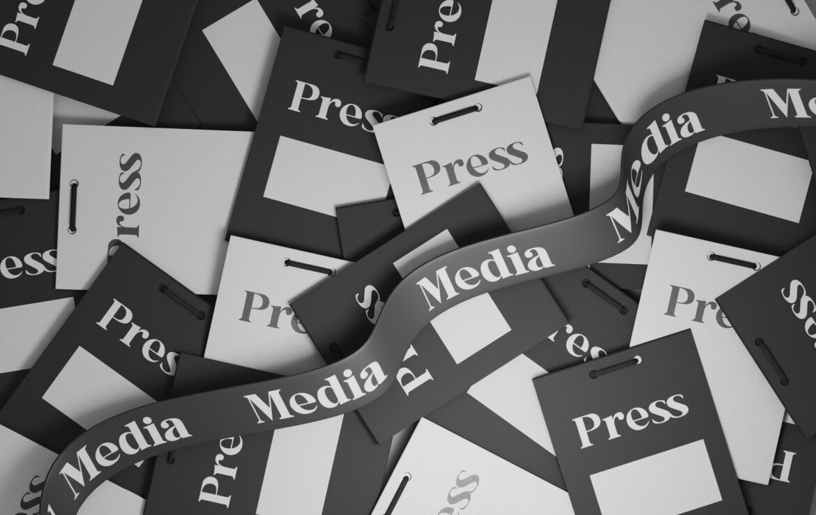 Abstract grayscale collage of press passes and media tags, representing media coverage and press in a jumble of cards and ribbons.