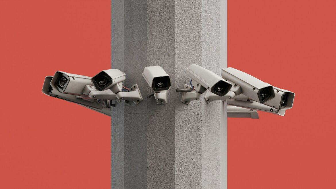 Multiple surveillance cameras mounted around a concrete column against an orange background, forming a protective security setup.